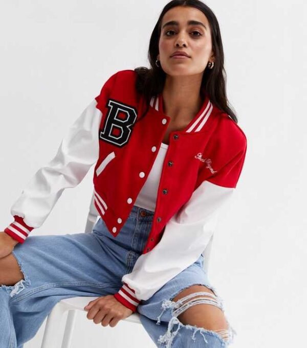 . Elevate your style with our Pink Vanilla Red Crop Varsity Bomber Jacket. Perfect for a trendy look, this jacket combines comfort and fashion effortlessly.